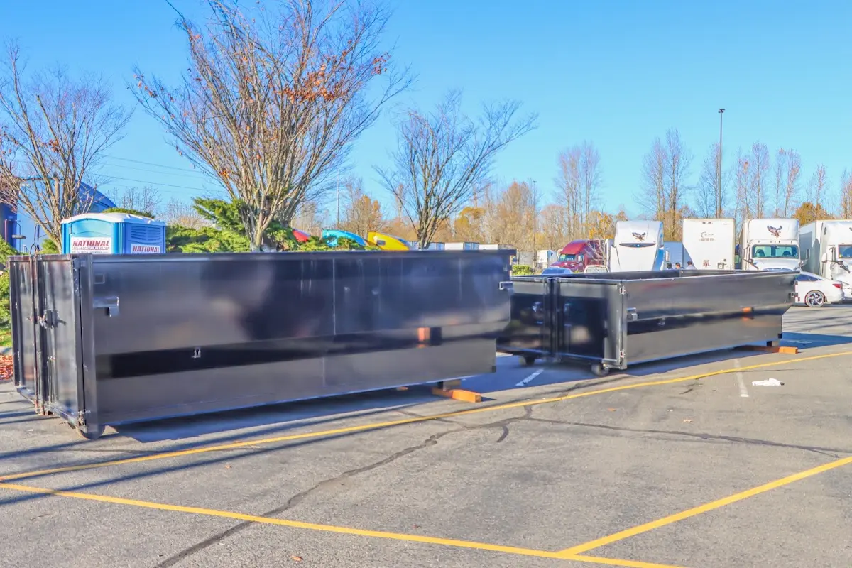 Professional dumpster rental service with roll-off container on residential driveway in Long Lake